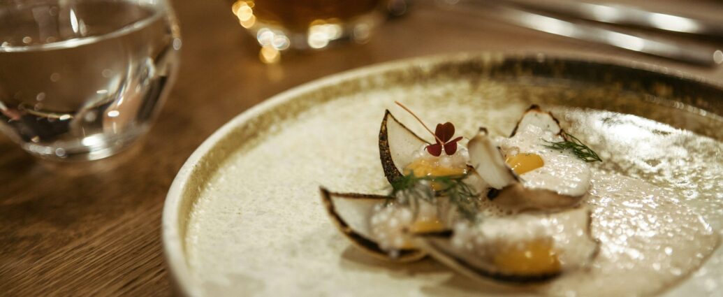 A small plate with a tiny portion of food on it.