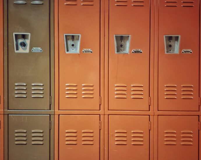 Orange lockers in school hallway representing Adolescence