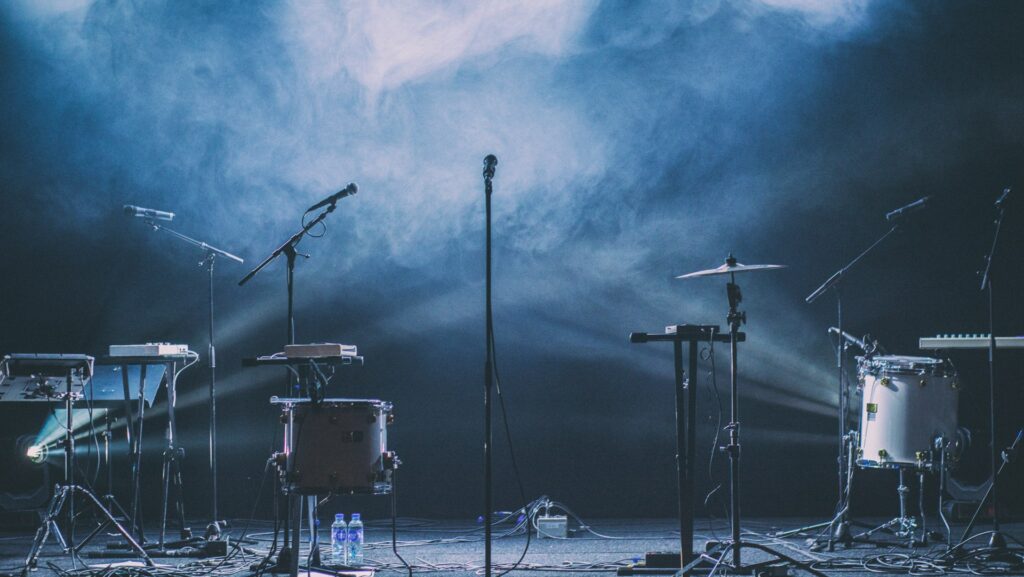 Microphones and musical instruments on stage for a music review