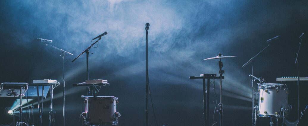Microphones and musical instruments on stage for a music review
