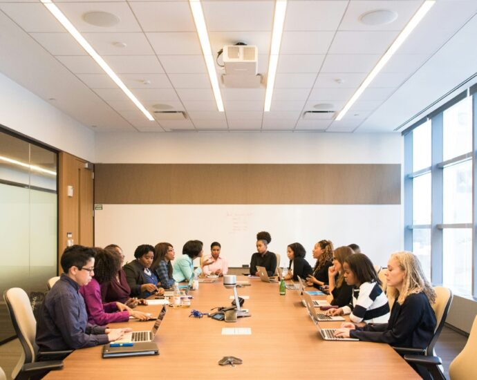 Women sitting around a large table in a business meeting in an office
