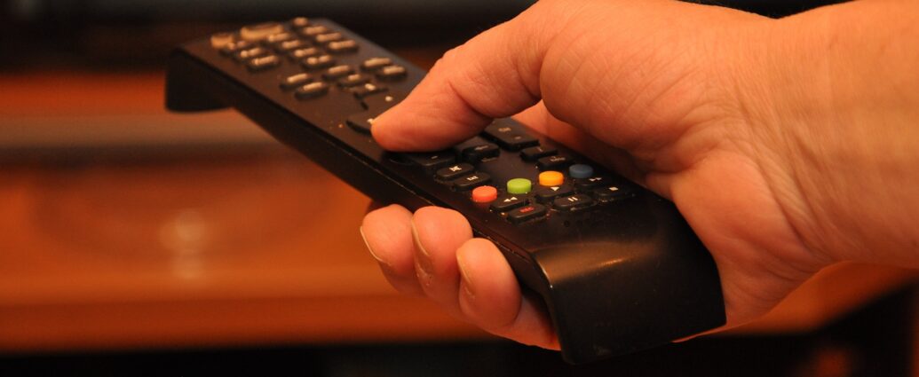 Hand holding remote control