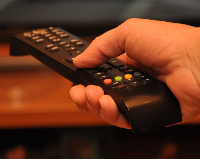 Hand holding remote control