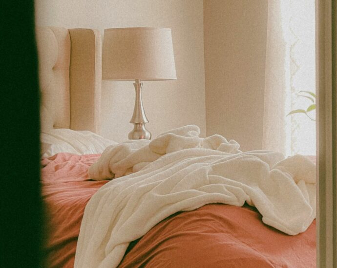 Perspective of peeking into a bedroom with a messy bed.
