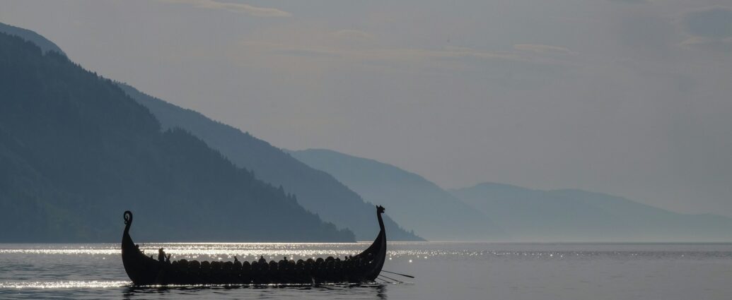 A long boat on a large body of open water.