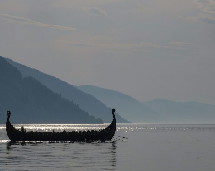 A long boat on a large body of open water.
